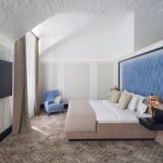 Why invest in professional hotel photography? This elegant bedroom shot by Kirill Toll showcases how proper lighting and composition can transform an ordinary room into an inviting luxury space.