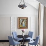 Professional hotel interior photography: dining setup with four chairs. Kirill Toll's expertise in hotel photography ensures that functional spaces are presented as attractive and comfortable areas for guests.