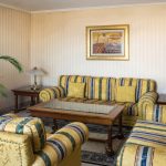 What makes a hotel living room look inviting? Professional interior photography by Kirill Toll uses careful styling and lighting to highlight the comfort of two sofas and an armchair, making guests imagine relaxing here.