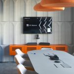 Оборудование ВКС Полы в multimedia переговорной комнате VK Звонки с яркой оранжевой консолью и стенами из серого акустического поролона.